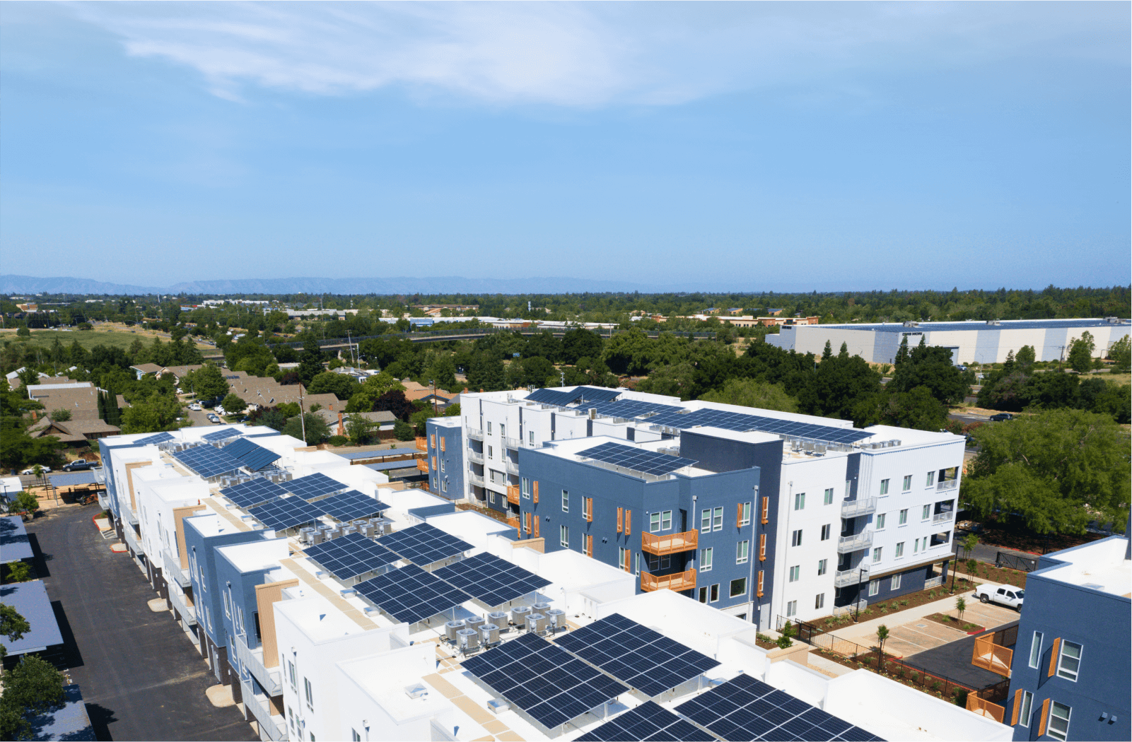 Aerial view of multifamily building with solar panels