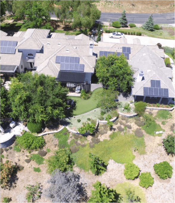 Aerial view of residential homes with solar panels