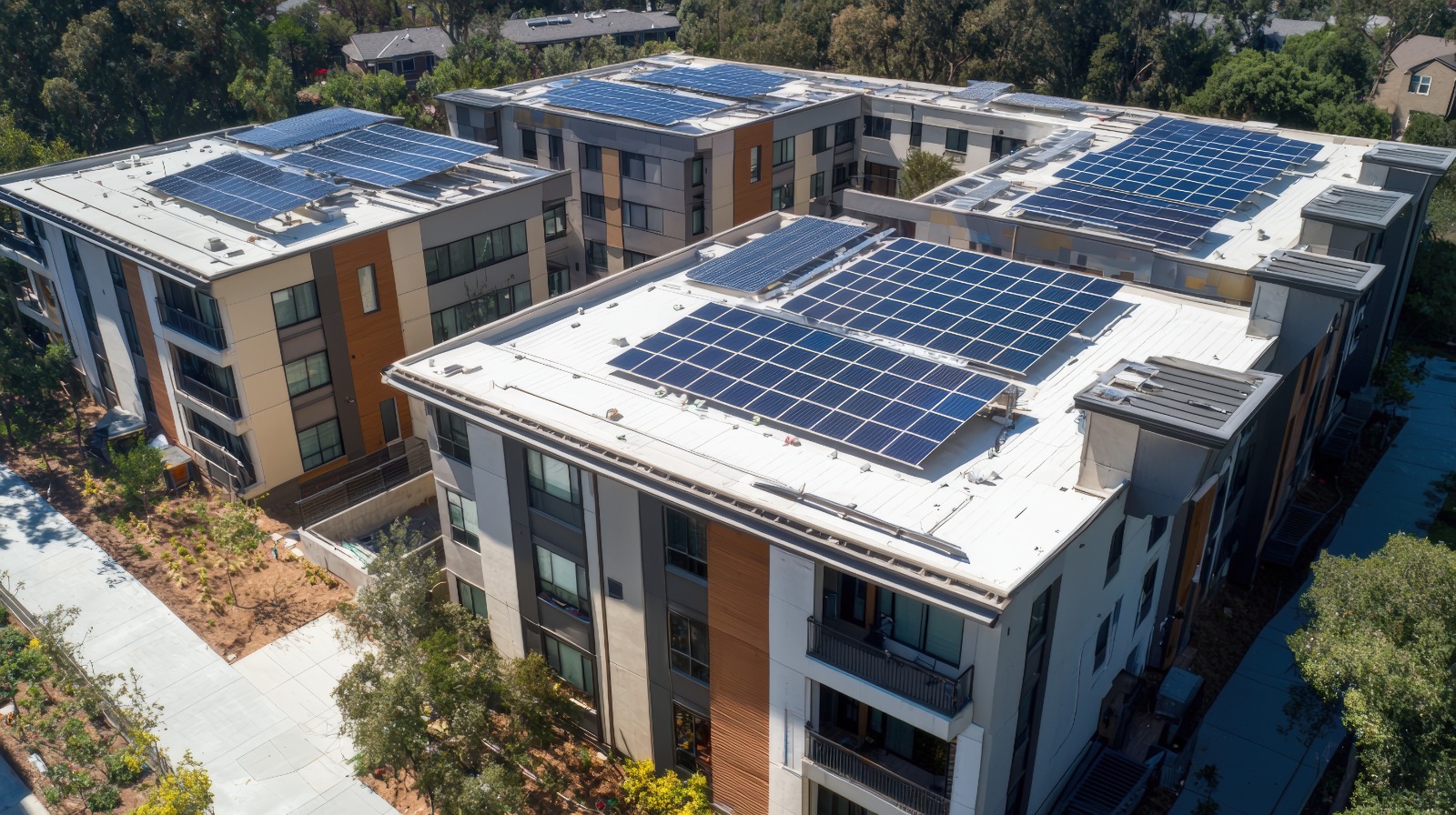 Aerial view of multifamily building with solar panels